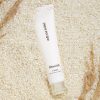 Papa Recipe Blemish Cream tube on rice grains, calming Korean skincare cream